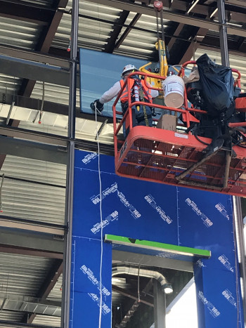 First piece of glass installed on North Concourse March 25 2019